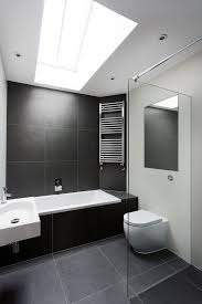 The gold hardware looks luxurious over white tiles. A Historic Horse Stable Transformed Into A Contemporary House By Ar Design Studio Slate Bathroom Large Bathrooms White Bathroom