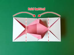 The wreath design is made from folded squares of green patterned paper. Homemade Origami Valentine Card Kissing Lips Popup