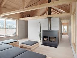 A Small Seating Area Is Tucked Into A Loft Like Space Tagged Living Room Sofa Wood Burnin Minimalist Living Room Design Minimalist Living Room Timber House