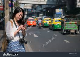 Asian Backpacker Woman Using Mobile Phone App For Car Sharing Service Or Using Phone App To Find Directions A Used Mobile Phones Chinese Women Thailand Holiday