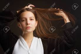 We did not find results for: Portrait Of A Brunette Girl In The Studio On A Plain Black Background In Black And White Pajamas With A Hood Pulling Her Hair Over Her Head With Her Hands Stock Photo
