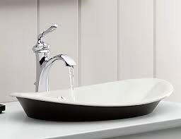 Gorgeous kids bathroom featuring a gray kohler brockway sink fitted with three polished nickel gooseneck faucets sitting under a large, rectangular, black framed mirror illuminated by three. Bathroom Sinks Undermount Pedestal More Kohler