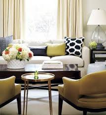 A Classic Modern Living Room With Cream Curtains A White Sofa With Scattered Graphic Cushions And Two Yell Gold Living Room Living Room Green Living Room Grey