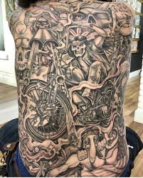 Motorcycle on upper back tattoo in blue circle. Motorcycle Tattoo Designs For Men Tattoomenu