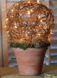 Position battery pack so it can rest inside urn, out of site, but accessible to turn on and off. Grapevine Ball Topiary With Lights Ball Topiary Grapevine Balls Topiary Diy