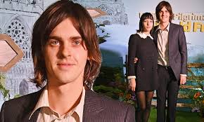 Earl Cave looks the spitting image of his dad Nick as he joins girlfriend  Devon Ross at screening