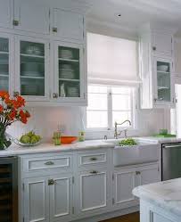 Cottage Kitchen Features Stacked Upper Cabinets And Inset Lower Cabinets Paired With Whi Glass Fronted Kitchen Cabinets Kitchen Interior White Cottage Kitchens