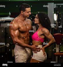 muscular woman and man in gym.sportive life. fitness. gym. hot curly woman.  handsome bodybuilder. sportive couple in gym Stock Photo - Alamy