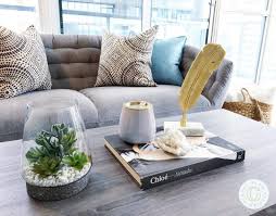 Green sofa with blanket and laptop near wooden coffee table with plant and smartphone near books on floor. Coffee Table With Storage Archives Coffee Table