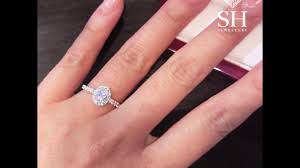 Halo rings feature a frame of smaller diamonds encircling the center stone. Classic Oval Halo Diamond Engagement Ring Sh Jewellery Diamond Engagement Rings Wedding Rings Melbourne
