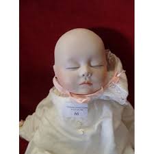 ORIGINAL JOYCE WOLF 1928 FABRIC BODIED DOLL WITH BISQUE HEAD. DRESSED IN  VINTAGE BABY NIGHTDRESS.