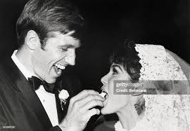 Actor Gary Collins gives his new bride a sample of the wedding cake... News  Photo