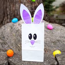 · this happy easter printable template has a beautiful picture of easter bunny holding the egg that has easter inscribed on it. How To Make The Easiest Paper Bag Bunny Craft