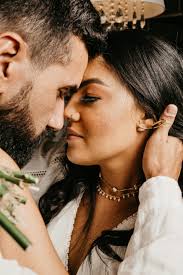 Crop ethnic newlywed couple in moment of kiss · Free Stock Photo