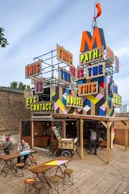 We Like The Fresh Unpretentious And Happy Look Of The Temporary Movement Cafe And Performance Space Built Next To The D Pop Up Cafe Colorful Cafe Pop Up Shops