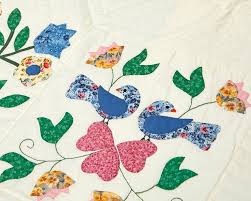 A pair of hand-stitched Amish or Mennonite quilts, by Mary Koons sold at  auction