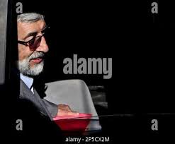Iranian presidential candidate, Gholam Ali Haddad Adel, sits in his car,  after attending a press conference in Tehran, Iran, Sunday, May 26, 2013.  Haddad Adel, a 68-year-old former parliament speaker, is currently