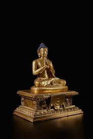 A gilt-copper alloy figure of Shakyamuni Buddha on a lion throne,