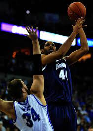 Akron S Zeke Marshall 44 Shoots Over Creighton S Ethan Wragge 34 In The First Half Of Their Ncaa College Ba College Basketball Game Ncaa College Akron Zips