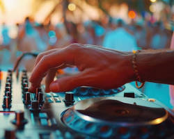 Image of DJ mixing music at a lively party