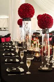 Our company provides a wide range of items for hire including furniture, table centrepieces, wedding stage designs, room decorations and backdrops and beautiful items to create full venue transformations. Deep Red Rose Balls On Cylinder Vases With Hanging Crystals And Black Lace Vase Wraps With 8 Le Wedding Table Linens Gala Decorations Lace Wedding Decorations