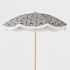 Black And White Outdoor Umbrella With Lights Bring Some Eye Catching Energy To Your Outdoor Area With This 9 Foot Patio Umbrella With Fringe From Opalhouse White Patio Furniture Patio Umbrella Opalhouse