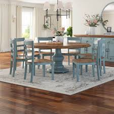 Kitchen tables are hot spots even when there's no food on them. Conway Farmhouse Two Tone Solid Wood Round Dining Table Chair Set