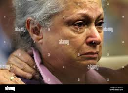 Ginny Kerry, mother of Julie and Robin Kerry, reacts as she listens to the  original tape of Reginald Clemons' confession to raping and murdering her  daughters, during a hearing Wednesday, Sept. 19,