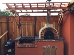 A Rustic Diy Wood Fired Pizza Oven And Argentine Grill With A Traditional Bbq Grill In The Back Brickwoodovens Com Brick Bbq Backyard Diy Pizza Oven
