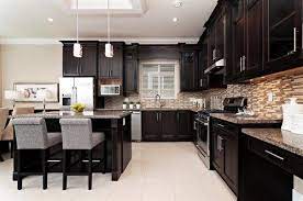 This will prevent the cabinets from looking like the sad loner in the room. Love The Dark Expresso Cabinets With The Light Tile Floor Home Kitchens Home Decor Kitchen Remodel