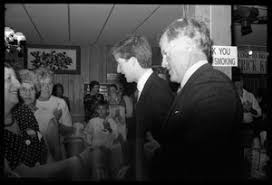 Sen. Edward M. Kennedy waves to supporters as he arrives at his son Patrick  Kennedy's campaign headquarters in Pawtucket: at left is long-time  supporter Frank DiPaolo, 98, Patrick Kennedy in background -