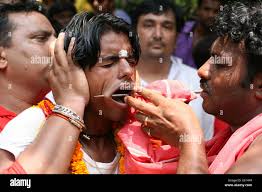 South Indian devotee gets his cheek pierced with a metal rod while  participating in a religious procession to praise the Hindu goddess Shetala  Mata in Chandigarh. © Kapil Sethi/Pacific Press/Alamy Live News