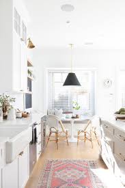 Black Light Over Round White Dining Table Transitional Dining Room