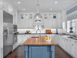 A combination of white painted cabinetry and rustic hickory cabinets create an earthy and bright kitchen. Cabinets American Cabinet Flooring Inc