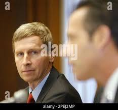 Gov. John Lynch, left, listens as Insurance Commissioner Roger Sevigny  explains the implementation of SB125, Thursday, Nov. 3, 2005 in Concord,  N.H. SB125 is a new health insurance law that they say