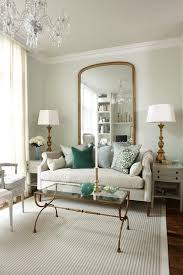 This Neutral Ivory Living Room Is Accented Neutral Because Of The Hint Of Green On The Couch Gold Living Room Blue And Gold Living Room Apartment Inspiration