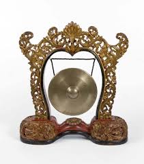 A round piece of metal that is hung in a frame and hit with a stick to produce a sound as a…. Gong Wikipedia