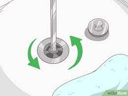 Unclogging a bathtub with a drain claw. 3 Simple Ways To Unclog A Bathtub Drain Naturally Wikihow