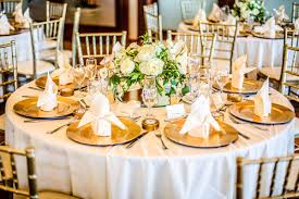Friends And Family Sat At Round Tables In Gold Chiavari Chairs With Gold Charger P Wedding Table Settings Gold Wedding Table Linens White Wedding Table Setting