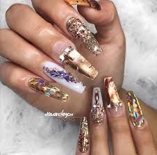 The accent nail is adorned with gold foil. Gold Nails With Diamonds Coffin Nails Diamond Nails Gold Nails Diamond Nail Designs