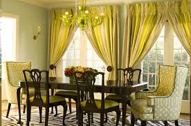 It includes a carved wood cabinet with an arched mirror and a vintage chandelier that hung from the ornate ceiling. Gray Yellow Curtains Transitional Dining Room Bonesteel Trout Hall