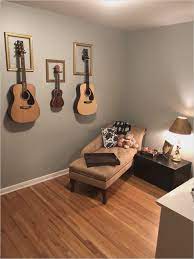 With strategic planning, living room furniture layout ideas for a long room can prevent the claustrophobic feel. Hanging Guitar In Living Room Wall Home Music Rooms Music Room Decor Music Bedroom