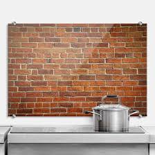 A rustic kitchen with brick walls and floors plus rich stained cabinets for a more dramatic look. Brick Wall Kitchen Splashback Wall Art Com