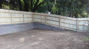 Yard Leveled Out Versa Lok Retaining Wall And Privacy Fence Sloped Backyard Sloped Backyard Landscaping Backyard Retaining Walls