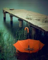 Orange Umbrella By The Jetty