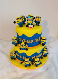 This minion cake uses delicious buttercream to frost the cake and fondant for the details. Two Tier Minion Themed Birthday Cake Minion Birthday Cake Cake Designs Birthday Cake