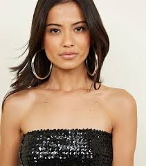 What is the purpose of earrings? An overwhelming majority of adult females  wear them, with many being the dangly 'can't miss them' kind. 'It makes me  feel more feminine'--okay, but why? -