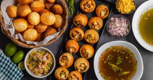 Pani Puri Street Food Chaat with crispy puris filled with spicy tamarind water and potatoes