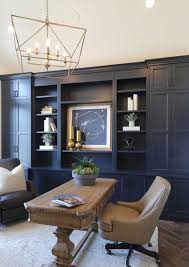 A bright and eclectic home a bright home office with navy walls and doors, bright polka dot chairs and a crazy gallery wall and a printed rug. 25 Chic Blue Home Offices In Various Styles Shelterness