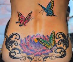 Before and after tattoo | cover up tattoo from tribal heart back tattoo to tree with blue flowers #coveruptattoo #tattoo #bodylanguagetattoo. Lower Back Cover Up Flying Butterfly And Lotus Flower Tattoos Butterfly Tattoo Designs Cover Up Tattoos Flower Tattoo Back